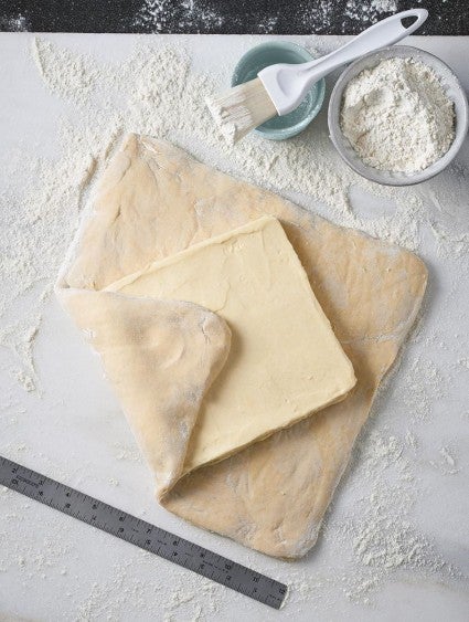 A butter block about to be locked into enriched dough for laminating