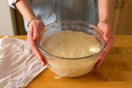 Baker holding a bowl of thickened pancake batter