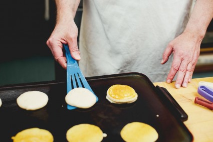 Flipping pancakes on a griddle