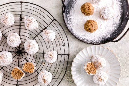 Horchata Polvorone cookies on a cooling rack, and in a bowl being covered in sugar