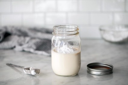 A mason jar of whipped cream with confectioners' sugar