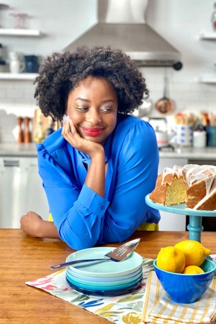 Vallery Lomas with a cake in the kitchen