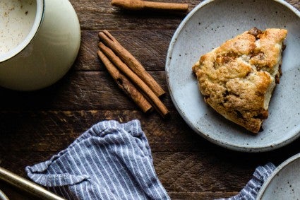 Cinnamon sticks next to cinnamon scone