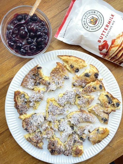 Kaiserschmarrn on a white swerving plate, King Arthur Buttermilk Pancake Mix and blueberry compote on the side.