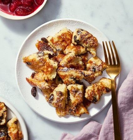 Kaiserschmarrn on a serving plate, fruit compote on the side.