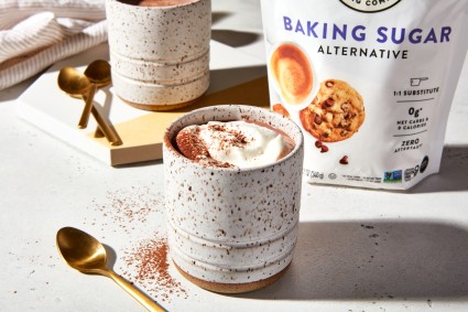 Mug of keto hot chocolate in front of bag of Baking Sugar Alternative 