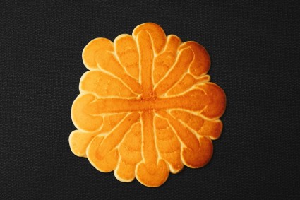 Baked pancake flipped to show finished snowflake design 