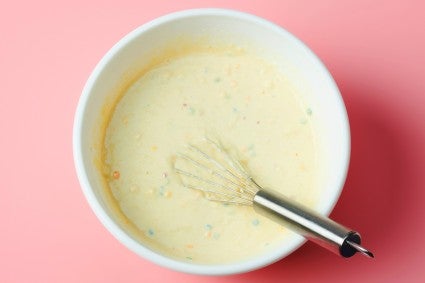 Whisked confetti pancake mix batter in bowl