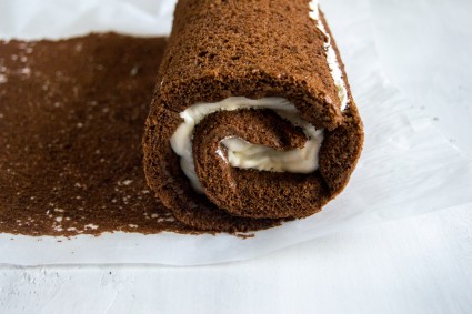 Close up of rolled cake with whipped cream filling 