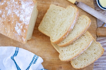 Basic Sourdough Bread sliced on a wooden tabletop