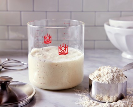 King Arthur Baking clear glass sourdough storage container with rising starter.