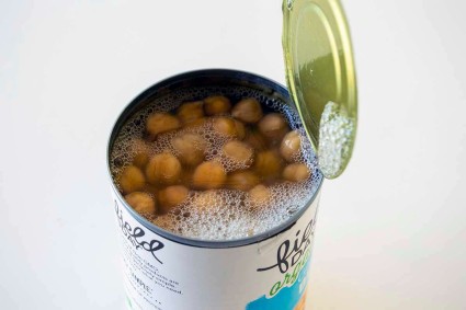Open can of white beans, showing aquafaba