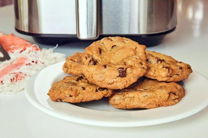 Plate of chocolate chip cookies in front of air fryer