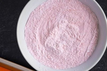 Bowl of pink freeze-dried fruit powdered sugar