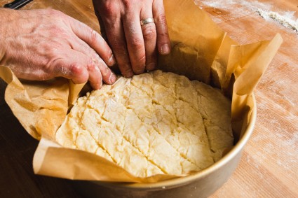 Placing kouign-amann dough in round cake pan