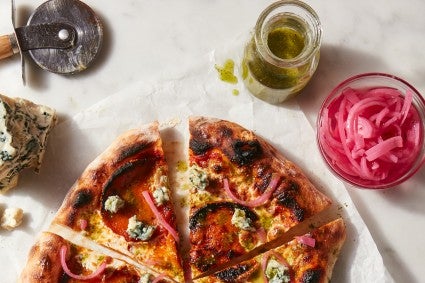 Bottle of vinaigrette next to baked No-Knead Artisan Pizza