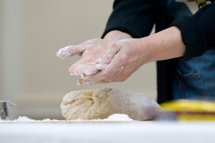 Rubbing flour between dough-covered hands 