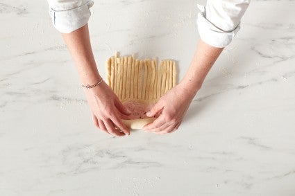 Baker rolling up wool roll bread