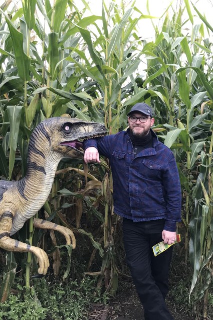 Ethan next to a fake dinosaur 