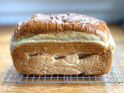 Loaf of bread with holes in the sides and a wrinkled top.