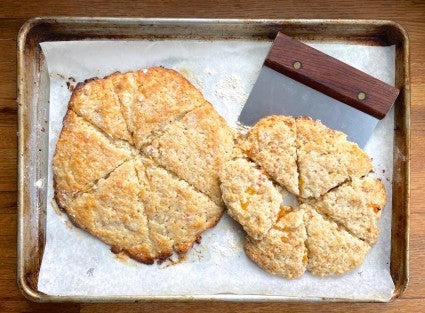 Two rounds of scones baked on a baking sheet, all run together into a blob.