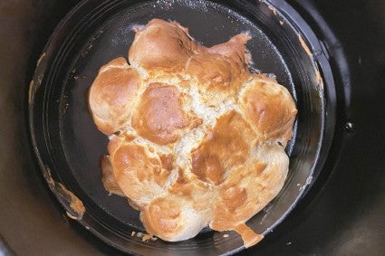 Scones made from melted ice cream and baked in an air fryer, all risen together and looking like a lumpy loaf of bread.