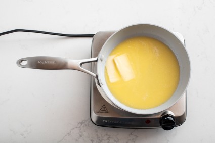 Saucepan of melted butter on burner