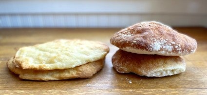 Loaves of sourdough Pan de Cristal showing difference in rise between a thin vs. thick starter