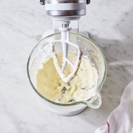 Cream being whipped in a stand mixer, starting to separate