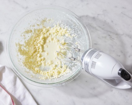 Cream whipped until separated using an electric hand mixer.