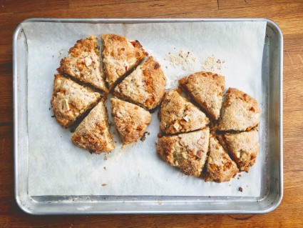Two rounds of scones, cut into triangles, baked on a piece of parchment on a half-sheet pan.