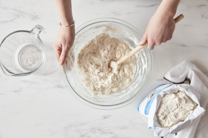 Stirring together no-knead bread dough