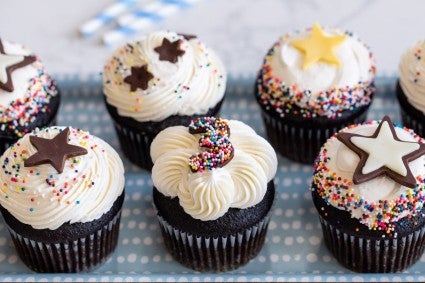 Chocolate cupcakes topped with stars and numbers made from modeling chocolate