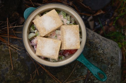 Unbaked fruit cobbler prepared to bake over a campfire 