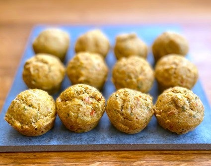 Pupcakes — muffin-shaped dog treats — lined up on a piece of slate.