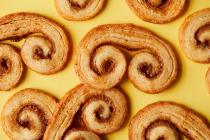 Malted milk palmiers (swirled pastries) on a yellow background