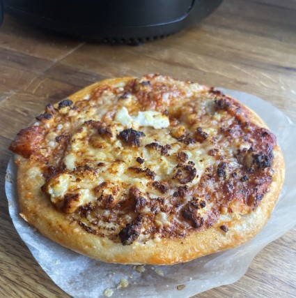 8" round pizza with a golden brown outer crust.
