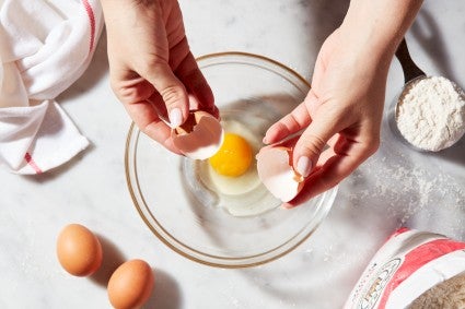 Egg cracked into a clear bowl