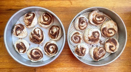 Cinnamon rolls in two 8" round cake pans, ready to rise.