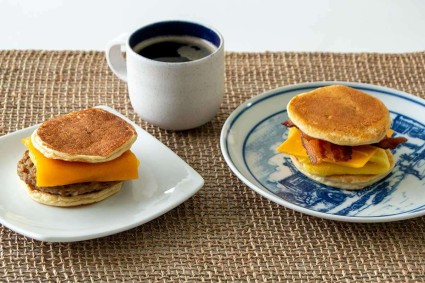 Two plated pancake breakfast sandwiches