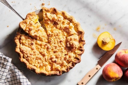 Ginger peach streusel pie on kitchen countertop 