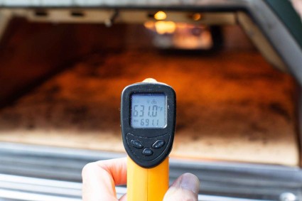 Infrared thermometer checking oven temperature