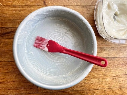 Round cake pan brushed with cake goop, a mixture of flour, vegetable oil, and vegetable shortening.