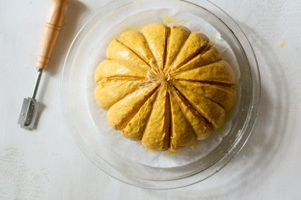 Bread dough with lines cut to look like a pumpkin 