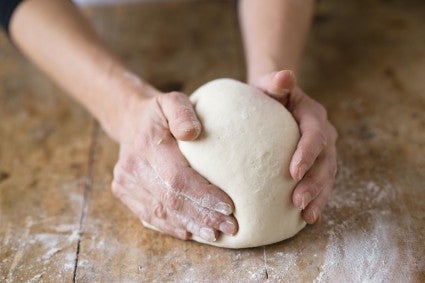 Hands kneading bread dough