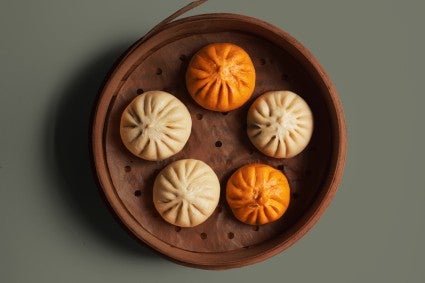 Orange and neutral bao in steamer