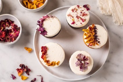 Cupcakes decorated with a flat top and garnished with edible flowers