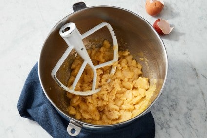 Pâte à choux being mixed in the bowl of a stand mixer 