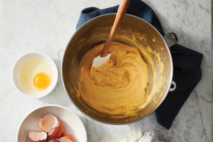 Pâte à choux being mixed in the bowl of a stand mixer 