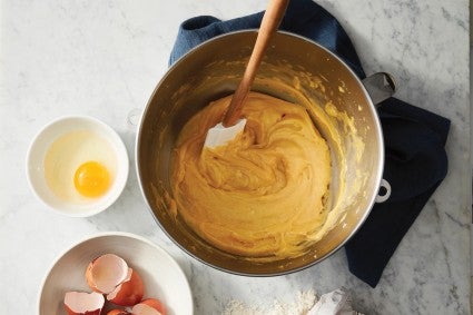 Pâte à choux being mixed in the bowl of a stand mixer 